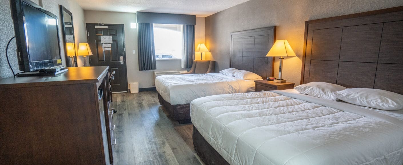 Double room in CHH Big Spring with a sitting area, a TV and night tables on each side of the beds